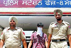 The rape accused, Sham Kumar, being taken to the local court in Mohali on Saturday