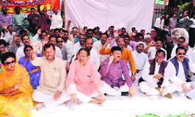 BJP leaders holding a dharna against the Central and state governments in Dehradun on Saturday.
