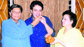 Akil Bakshi's parents offer him sweets on his selection in the Civil Services Examination at Nurpur on Saturday.