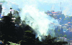 Smoke rises during a forest fire near Shimla on Saturday.