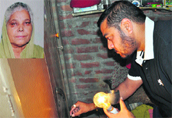 An official takes fingerprints from an almirah at the murder site in Ludhiana on Saturday. A Tribune photograph
