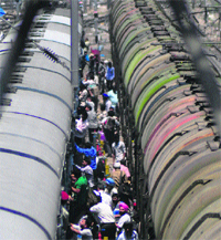 Passengers board a train from the opposite side of the platform at the Ludhiana railway station. Tribune Photo: Himanshu Mahajan
