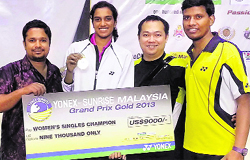 PV Sindhu strikes a pose with the winners bounty. PTI