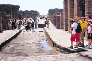 Tourists throng the cobbled streets