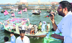 Usman Ghani, an Independent candidate for the provincial assembly, addresses supporters during a rally in the Arabian Sea in Karachi on Friday. AFP