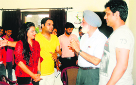 Jatinder Brar (second from right) greets Kapil Sharma (in yellow T-shirt) at Punjab Natshala in Amritsar on Sunday. 