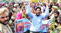 Protesting teachers raise slogans against the state government in Bathinda on Sunday