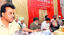 A leader of the postal employees union speaks during a meeting held in Bathinda on Sunday