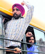 Teachers raise slogans against the state government as they were being transported to various police stations in the district in Bathinda on Sunday