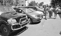 SSP GS Bhullar (extreme left) inspects recovered vehicles at Phase I, Mohali, on Sunday. 