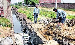Following the directions of the PSIEC authorities, labourers disconnect the common outlet carrying untreated water of tanneries into the Kala Sanghian drain in Jalandhar on Sunday