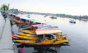  A long row of tourist boats lying idle at a jetty on the Dal Lake in Srinagar on Sunday. 