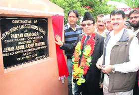 Jammu and Kashmir Finance Minister Abdul Rahim Rather lays the foundation stone of a bridge at Panzan in central Kashmir's Budgam district on Sunday. 