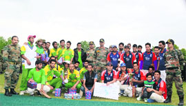 Players with their trophy after winning a match in the Chinar Cup Kashmir Premier League in Srinagar on Sunday. 