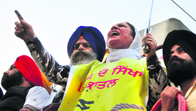 Riot victims raise slogans against the Union Government during a rail roko protest in Ludhiana on Sunday.