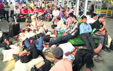 Passengers wait at the railway station as several trains were delayed due to the protest.