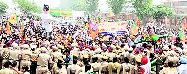 Policemen try to stop BJP leaders and workers from moving past barricades at the Attari-Wagah border during their anti-Pakistan protest on Sunday