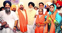 CM Parkash Singh Badal with SAD leader Prem Singh Chandumajra (extreme left) and Harminder Singh Harjis family members (wearing siropas) in Mohali on Sunday