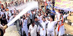 Police uses water canons to control the mob