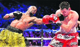 Floyd Mayweather lands a punch on Robert Guerreros chin. Mayweather retained the WBC welterweight championship on Sunday.