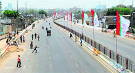 Youth play cricket on a street during a strike in Karachi on Sunday, a day after a bomb explosion took place near a party office of the MQM.
