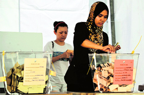 Malaysian voters cast their ballot during the country's 13th general elections in Kuala Lumpur on Sunday.
