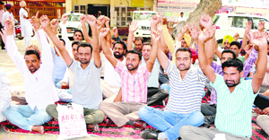 Gram Sevaks stage protest in Bathinda on Monday in support of their demands.