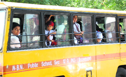 Students forced to stand in a school bus due to unavailability of an adequate number of seats