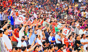 Residents throng the stadium with colourful and interesting placards in Mohali on Monday. 