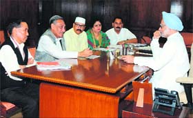 A delegation of Uttarakhand Congress leaders led by Chief Minister Vijay Bahuguna meets Prime Minister Manmohan Singh in Parliament in New Delhi on Monday