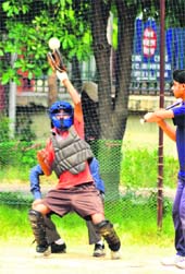 A player tries to stop the ball during a semi-final match of the Softball Championship. 