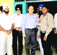 Jagraon MLA SR Kaler felicitates pugilist Amandeep Kaur during a function at Sri Ram College, Dalla, near Jagraon. 
