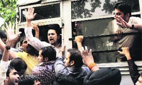 BJP Yuva Morcha president Anurag Thakur being detained by the police from outside Pawan Kumar Bansals residence in New Delhi on Monday.