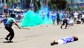Islamists run as policemen fire rubber bullets towards them during clashes in Dhaka on Sunday.