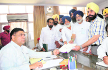 Gurpreet Maluka, along with Sikandar Singh Maluka (blue turban), files nomination paper for the Zila Parishad and Panchayat Samiti elections from the Bhagata zone in Bathinda on Tuesday. 