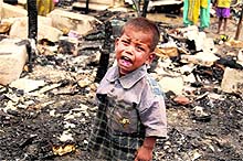 A three-year-old child cries after his hut was gutted at Sanjay Colony in Chandigarh on Tuesday