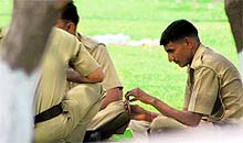 Policemen deployed at Indradhanush Auditorium seen playing cards