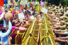 Activists of the BJP break earthenware pots during a demonstration against the water shortage in Delhi, at Delhi Secretariat on Tuesday.