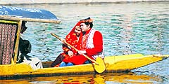 Tourists enjoy a shikara ride on the Dal Lake in Srinagar on Tuesday