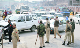 Policemen go about regulating traffic in Srinagar on Tuesday.