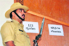 A security person guards electronic voting machines in Chikmagalur district on Tuesday. 