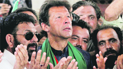 PTI chief Imran Khan addresses his supporters after his visit to the mausoleum of Mohammad Ali Jinnah in Karachi on Tuesday.  Reuters