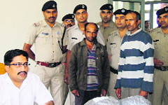 The police with the two drug peddlers in Dehradun on Wednesday. A Tribune photograph 