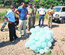 Jawali police personnel examine Pakistani balloons in the Pong Dam reservoir area at Dhameta on Wednesday morning.