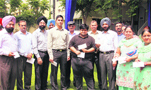 NDA cadets along with their parents show their cheques during a function at the District Sainik Welfare Board in Jalandhar on Wednesday. 