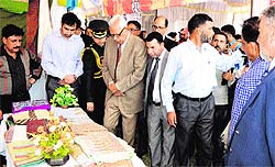 Governor NN Vohra looks at handmade goods on display at a stall in Srinagar on Wednesday