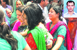 Relatives try to console Ranju Gupta, mother of Sachin (inset), who was found murdered, at the cremation ground in Ludhiana on Wednesday.