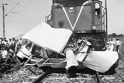 People carry out rescue work after a train hit a car at Dhalpur in Dhenkanal district of Odisha on Wednesday
