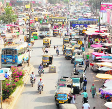 Drivers wait for passengers by parking their auto-rickshaws on the road in a haphazard manner outside the Inter-State Bus Terminal in Amritsar on Thursday.