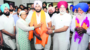 Rachpal Singh, the official candidate of the Congress from the Bhagta Bhai constituency being welcomed by the Education Minister and a senior SAD leader, Sikandar Singh Maluka, into the party fold on Thursday.